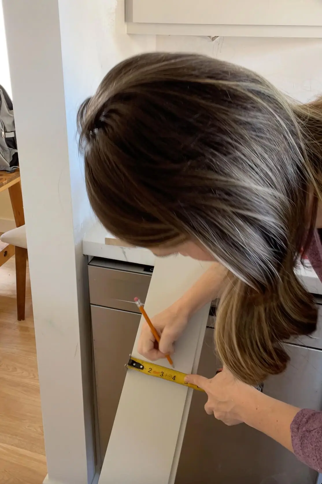 Measuring for a shiplap backsplash.